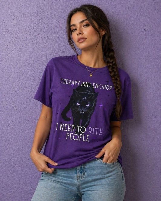 Woman wearing a purple witchy t shirt with black cat design and funny gothic quote “therapy isn’t enough I need to bite people”