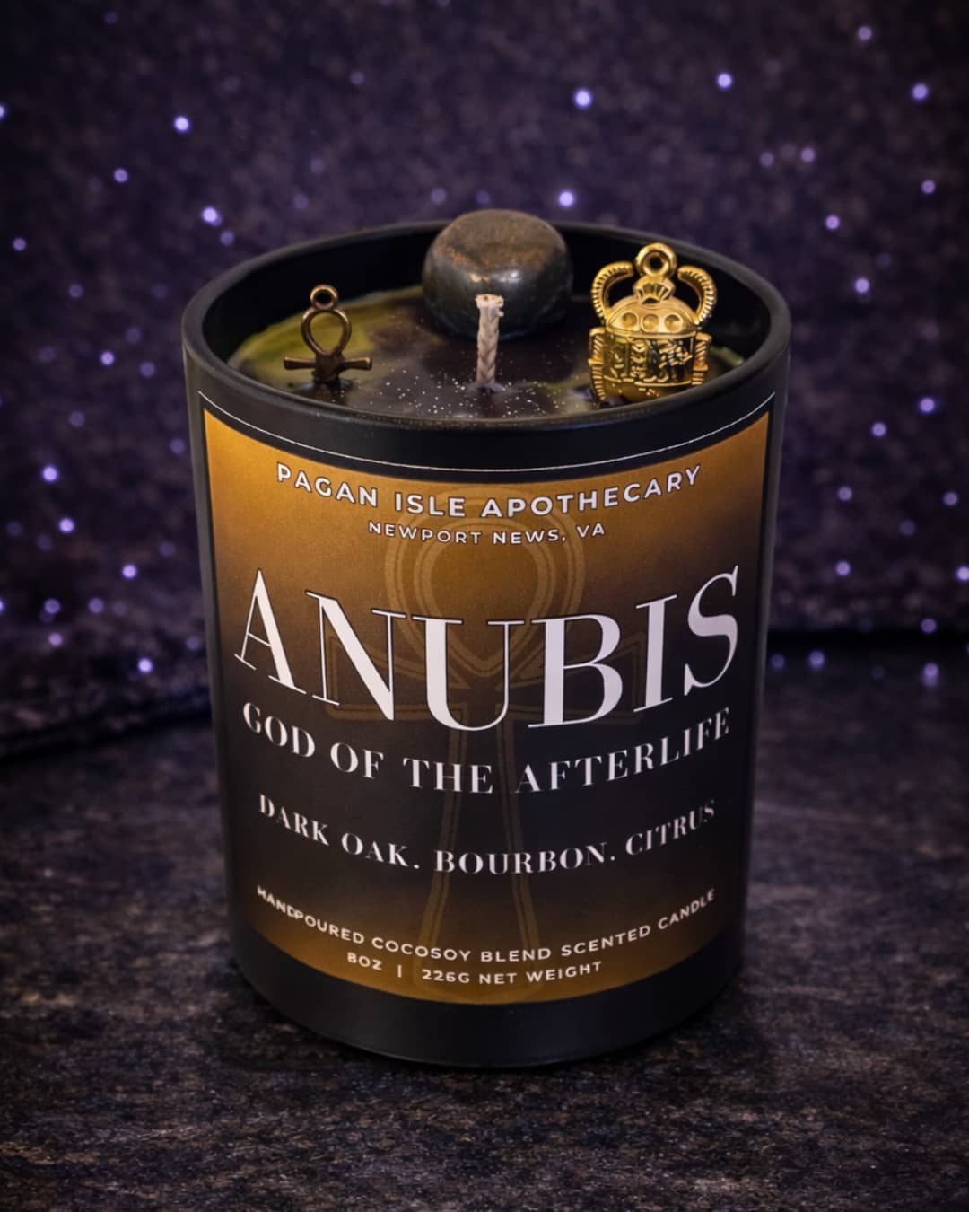 Anubis deity crystal candle inspired by the Egyptian god of protection and the afterlife, featuring dark mystical tones and crystal adornments for ritual use.