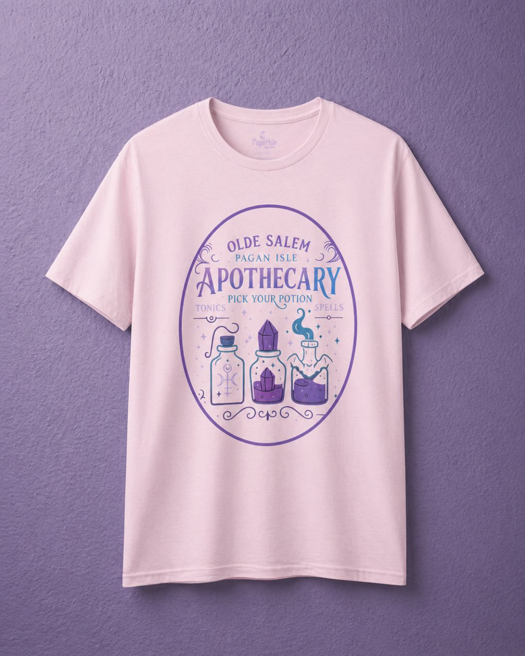 Light pink witchy t shirt with apothecary shirt design featuring potion bottles in soft mystical tones