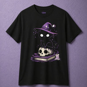 Black witchy t shirt with cute witch shirt design of black cat sitting on skull and spell book