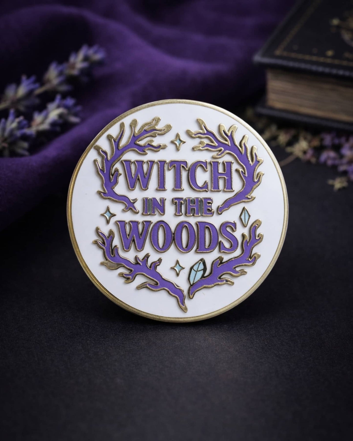 Pin with 'Witch in the Woods' text on a dark background