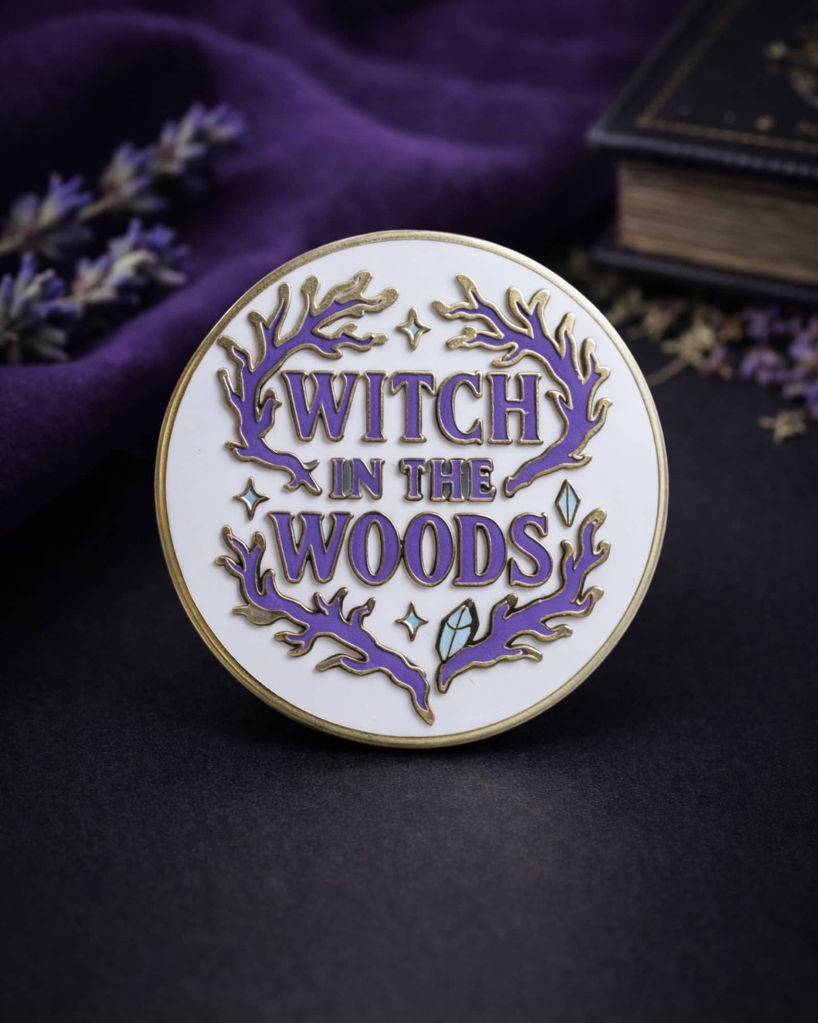 Pin with 'Witch in the Woods' text on a dark background