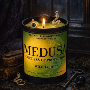 Medusa crystal candle adorned with protective crystals, crafted for warding, strength, and empowerment magic.