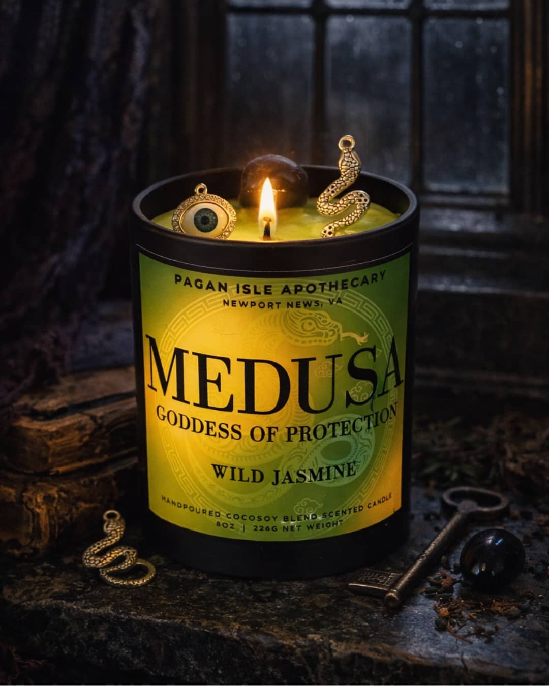 Medusa crystal candle adorned with protective crystals, crafted for warding, strength, and empowerment magic.