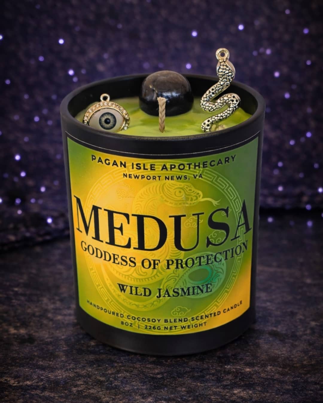 Medusa deity crystal candle symbolizing protection, rage, and reclaimed power, crafted with dark tones and crystals for shadow work and altar decor.