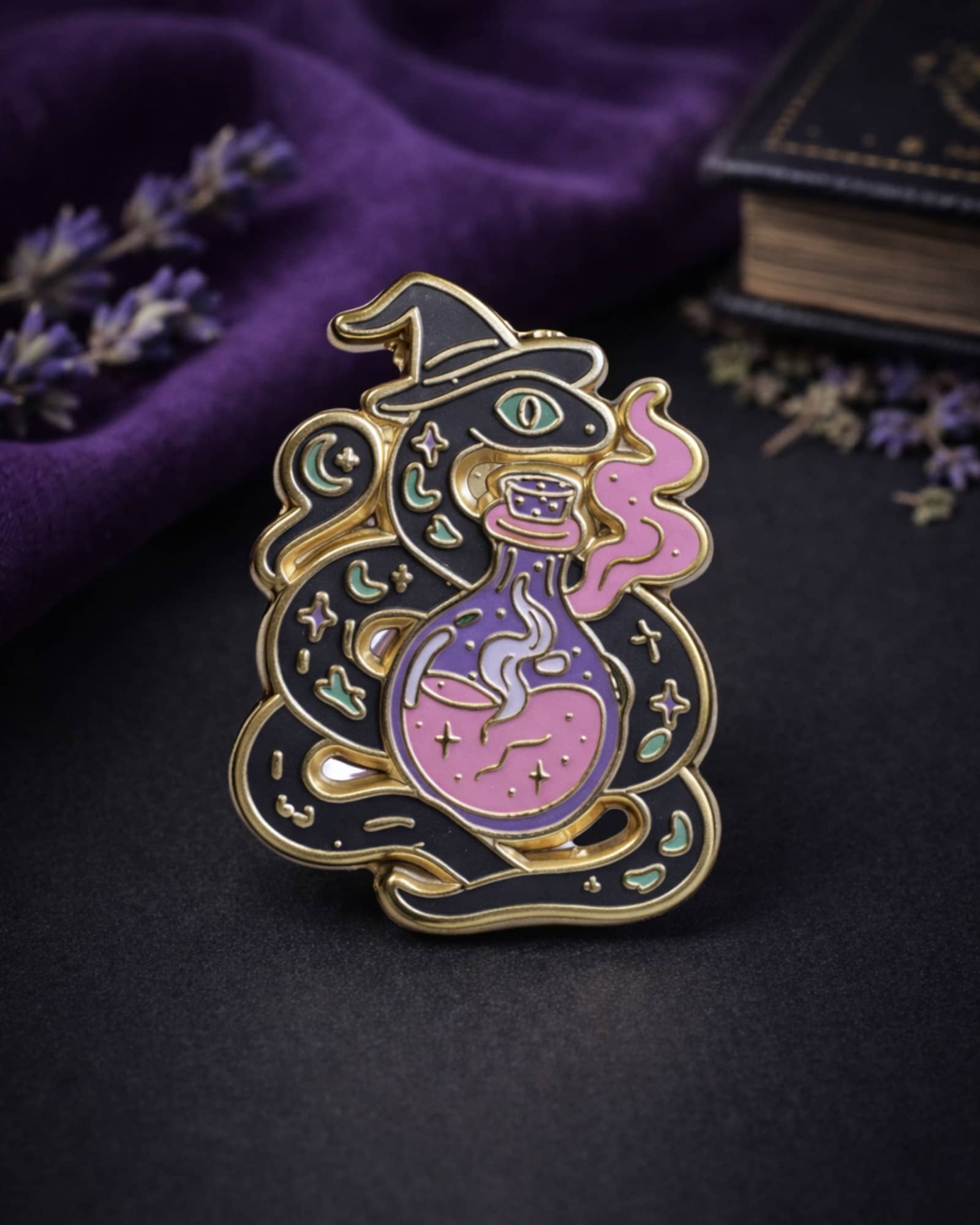 Enamel pin with witch design on a dark background