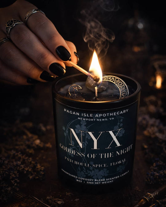 Nyx crystal candle with deep-toned crystals, crafted for shadow work, dreams, and nocturnal magic.
