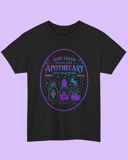 Flat lay of the black Olde Salem Potion Parlor t-shirt showcasing the vintage potion parlor graphic on a dark background.