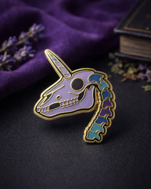 Unicorn skull pin with colorful design on a dark surface