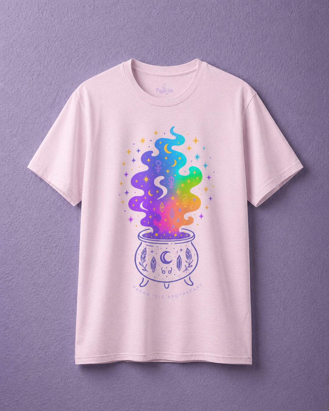 Light pink witchy t shirt featuring colorful cauldron design in soft witch aesthetic clothing style