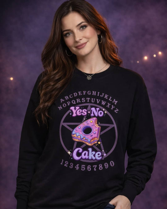 Model wearing the Yes No Cake sweatshirt featuring a playful witchy design, styled in a moody studio setting with dark magical tones.