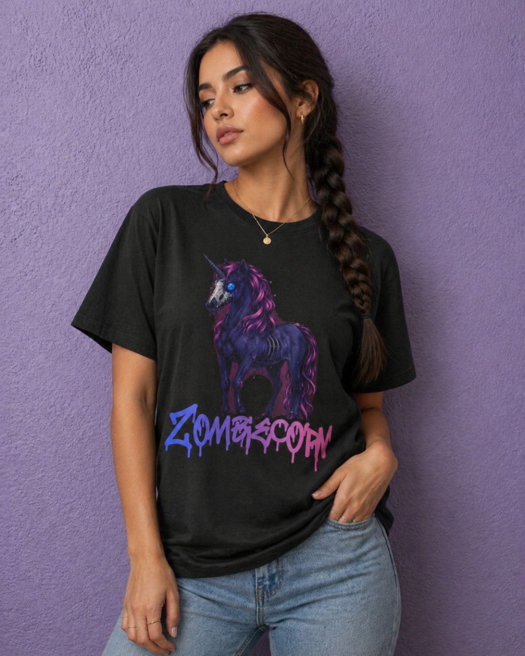 Woman wearing a black spooky shirt with Zombiecorn creepy unicorn design styled as casual gothic outfit