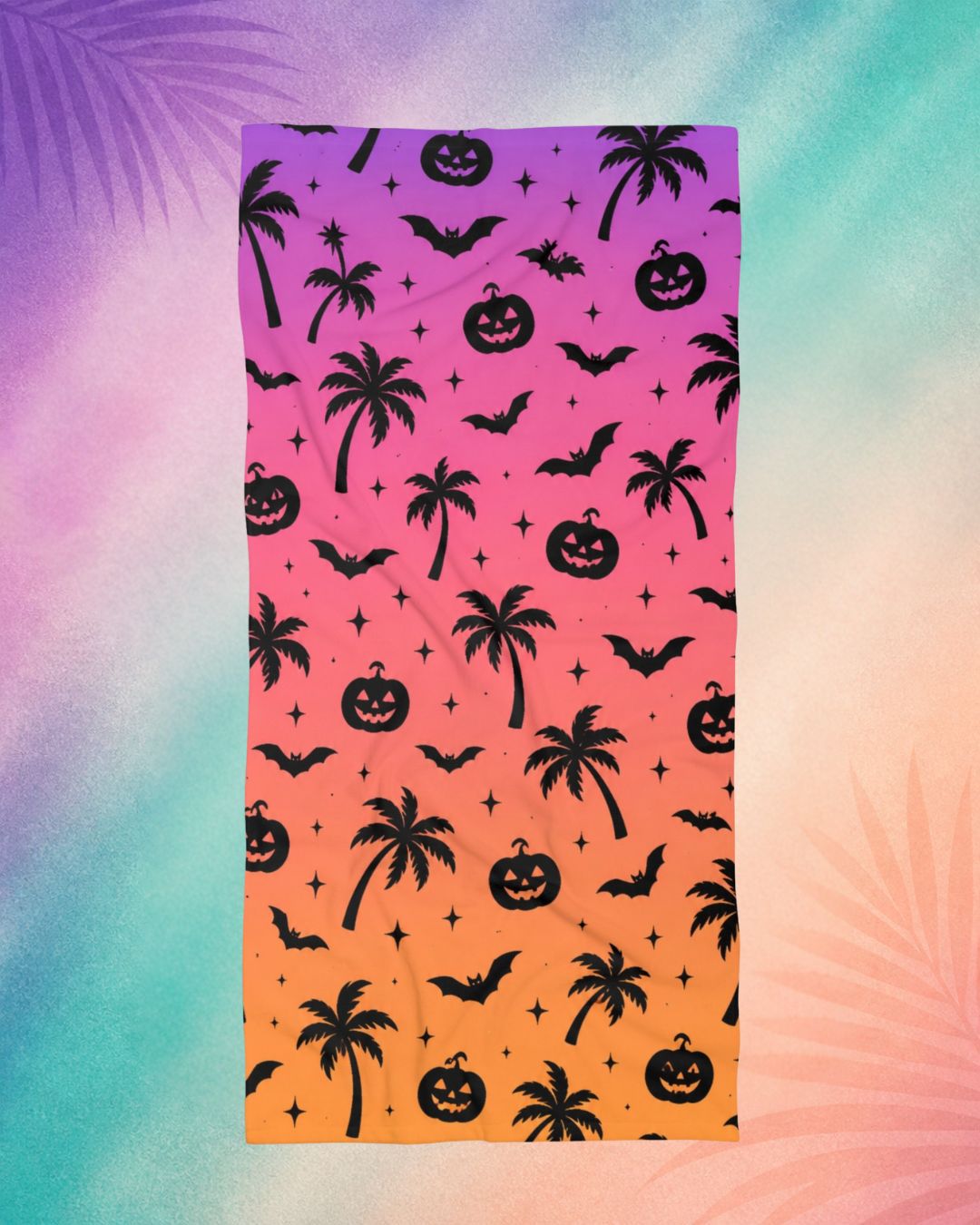 Summerween beach towel with palm trees, bats, and pumpkin pattern on pink and orange gradient, spooky beach aesthetic